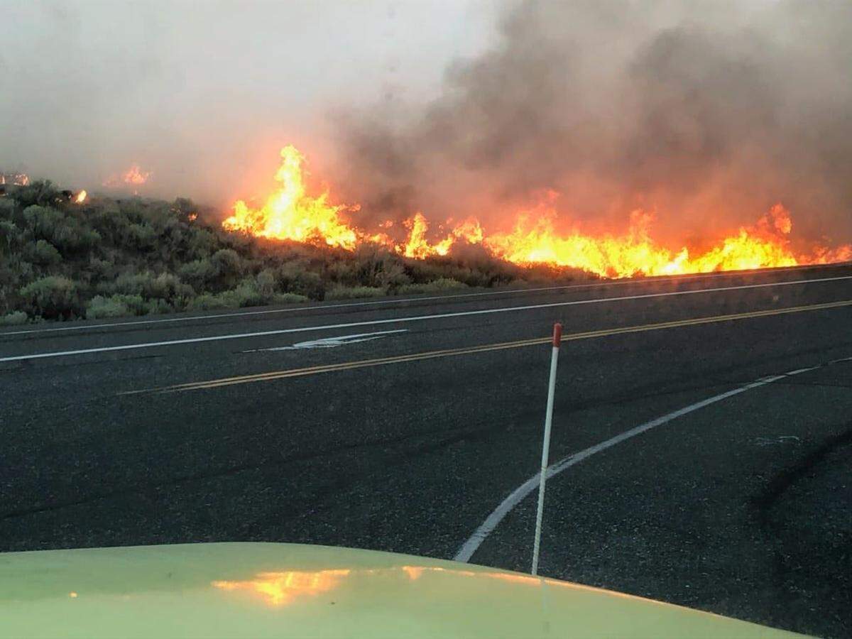 Fire came near to the road as it burned sagebrush near the intersection of Highway 397 and Nine Canyon Road.