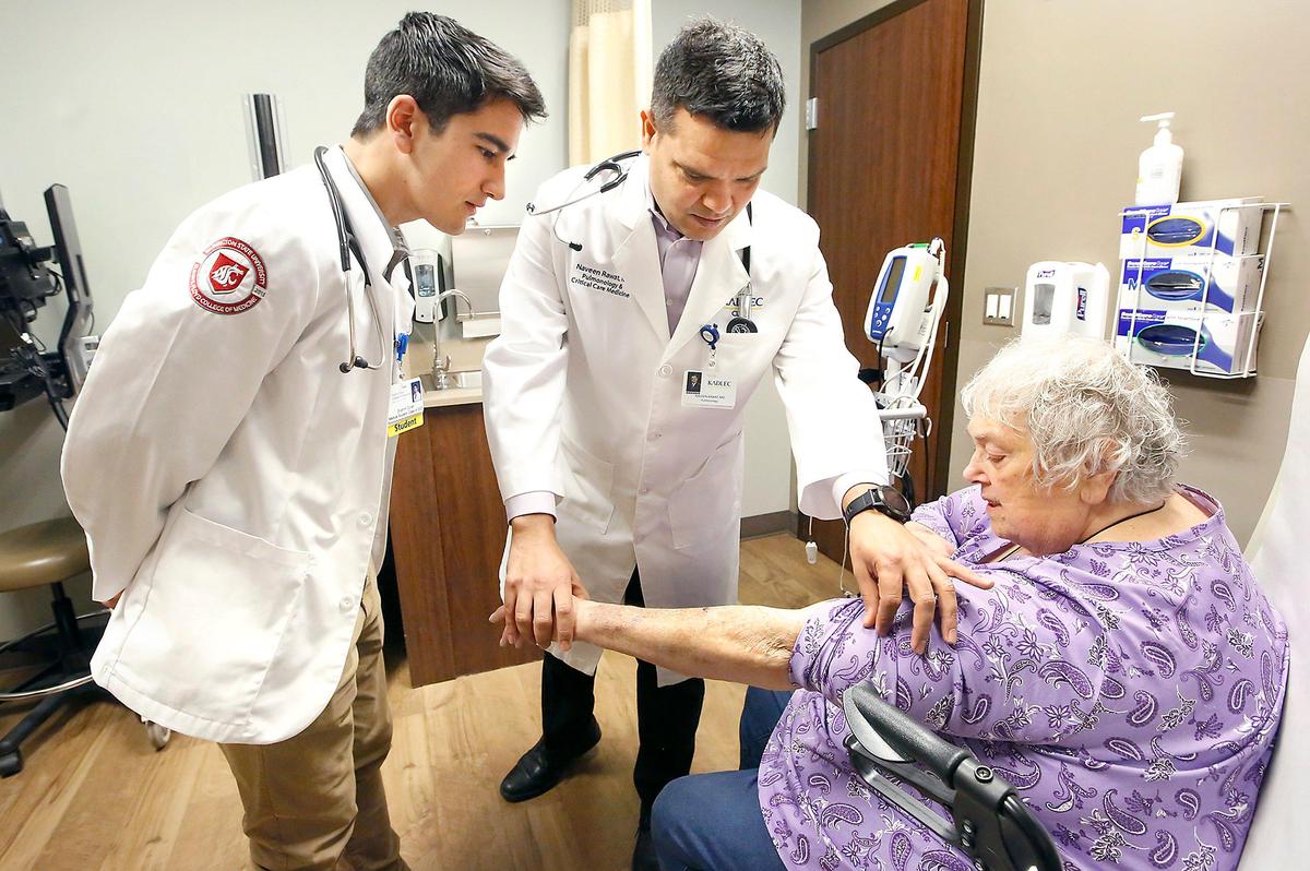 WSU medical student Brahm Coler, left, participates in a examination of patient Sherry Hamlin of West Richland with Dr. Naveen Rawat recently at the Kadlec Pulmonology Clinic in Richland. Coler is following in the medical footsteps of his father and grandfather. His grandfather, Rod Coler, was a longtime doctor in the Tri-Cities. Watch a video at: tricityherald.com/video