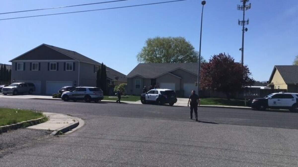 Kennewick police surrounded a Hood Avenue home Monday morning after an alert neighbor spotted a criminal combing the area.
