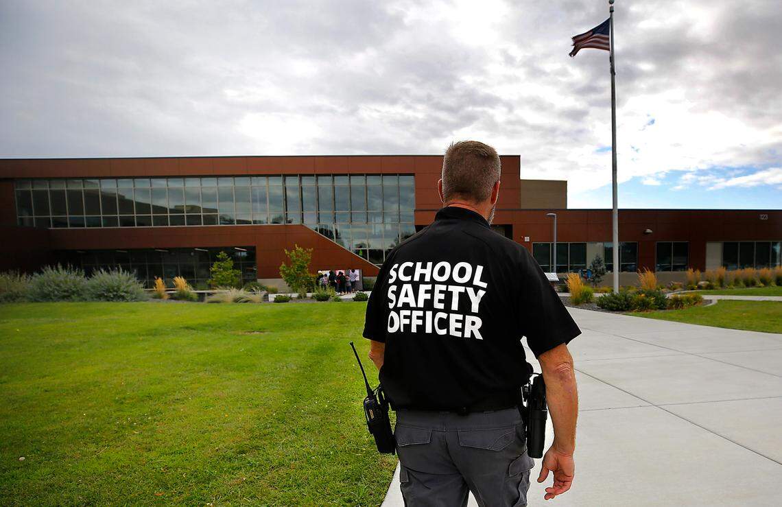 School Safety Officer Scott Child walks outside Amistad Elementary School in Kennewick on the first day of classes for the 2023-24 school year. 