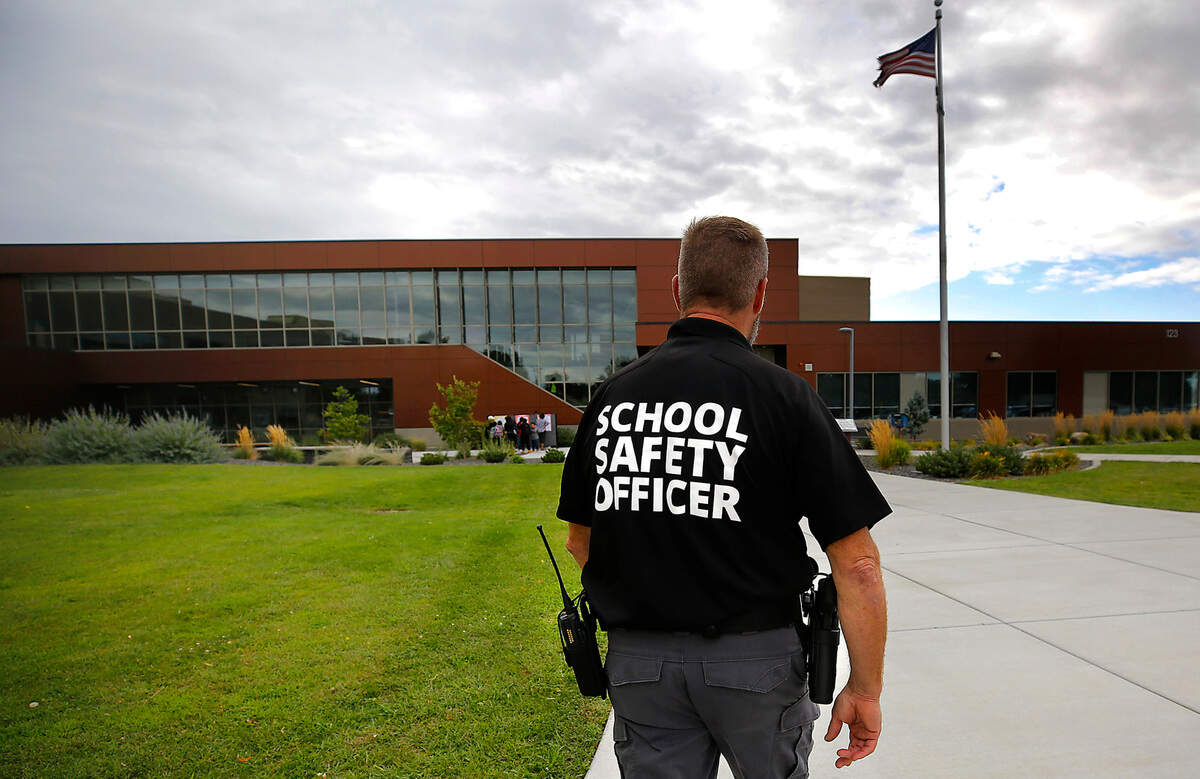 School Safety Officer Scott Child walks outside Amistad Elementary School in Kennewick on the first day of classes for the 2023-24 school year.