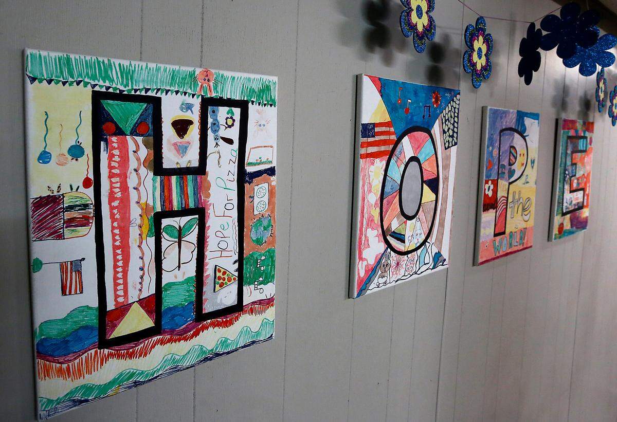 A handmade sign spelling out HOPE is posted on a wll in the children’s play area at the women and children facility.