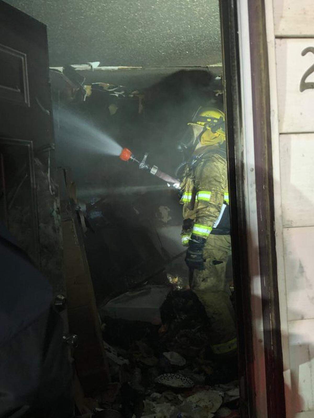 A firefighter works inside the house that burned at 2620 W. Seventh Ave., Kennewick