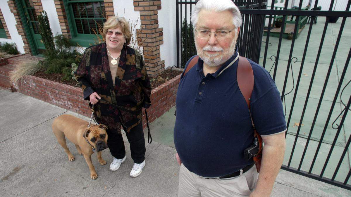 Duncan and Gail Dohmen of Covington are preparing for a trial in Benton County District Court after he was charged last year in Prosser for unlawfully displaying a gun. Dohmen, a member of OpenCarry.org, pulled into Prosser to walk his dog, Aki, during a trip with his wife to Colorado when a manager at McDonalds called police after he walked into the restaurant carrying his pistol in a shoulder holster.