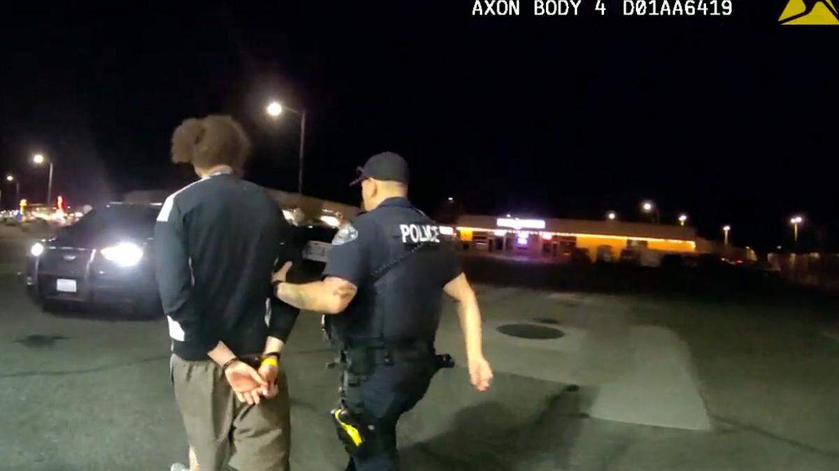 A Richland police officer detains one of two men found in a vehicle witnesses reported to be involved with a drive-by shooting March 25, in the Uptown Alley near Lee’s Tahitian.