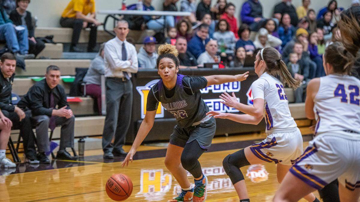 Pasco’s A’niyah Heavens brings the ball down court past Hanford’s Olivia Davis in a recent game.