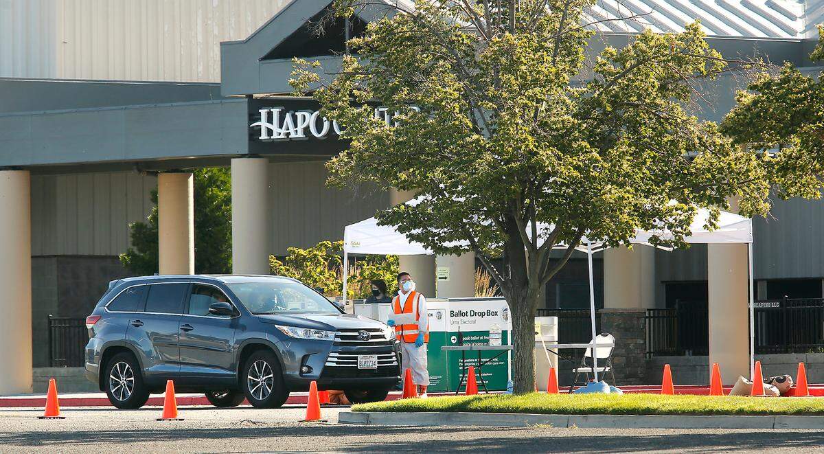 A vehicle waits to move toward the COVID-19 drive-thru testing station at the HAPO Center in Pasco. Two nonprofits are bringing more COVID testing to the Tri-Cities area.