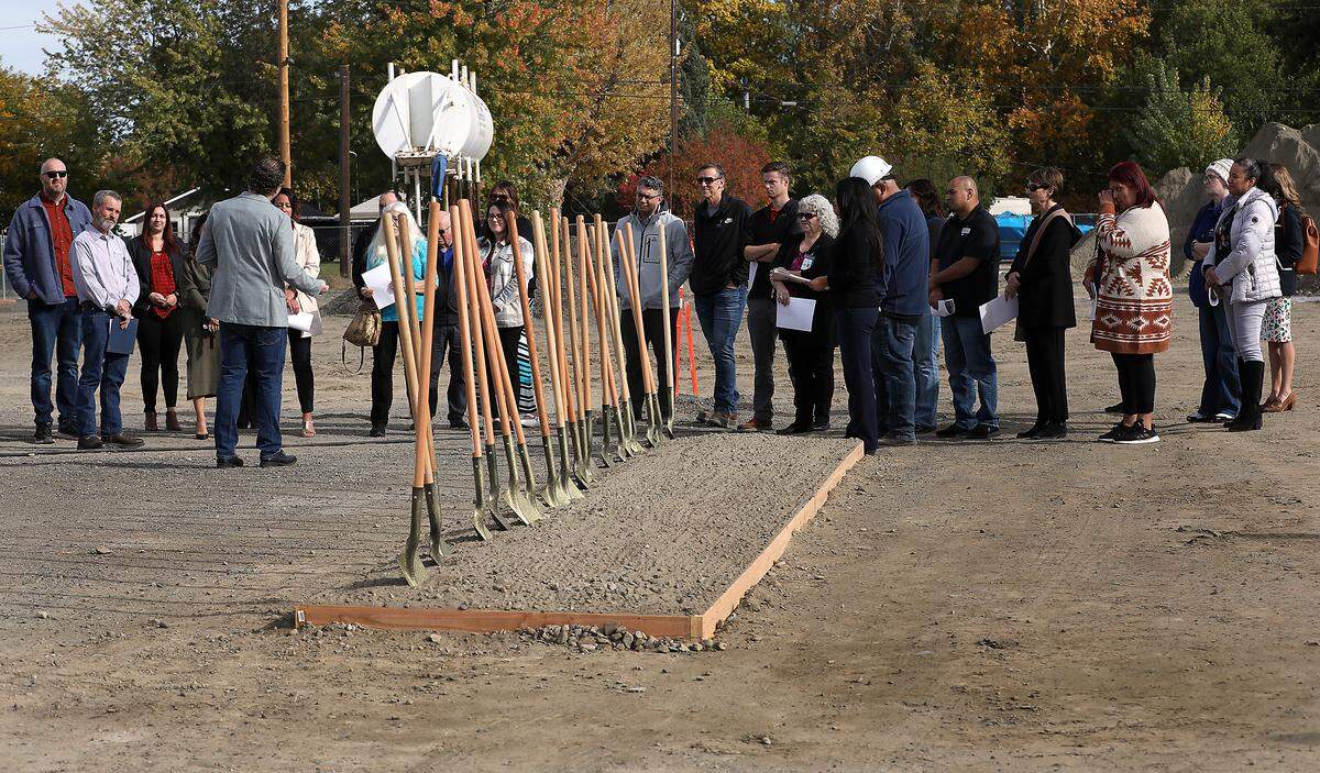 About 30 people take part in the groundbreaking ceremony for the new Sunset Ridge Townhomes project.