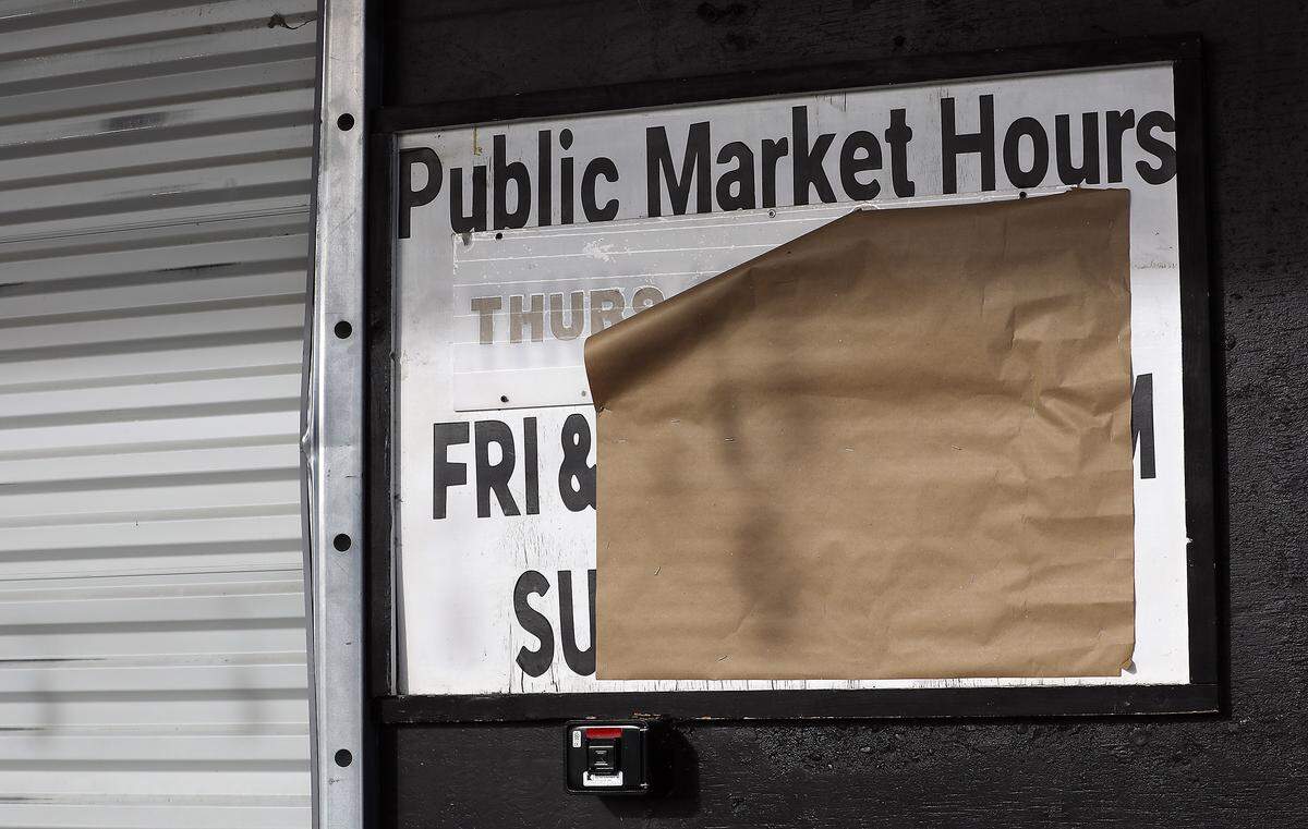A piece of brown paper covers the hours for The Public Market at Columbia River Warehouse at 10 E. Bruneau Ave. Building C in downtown Kennewick.