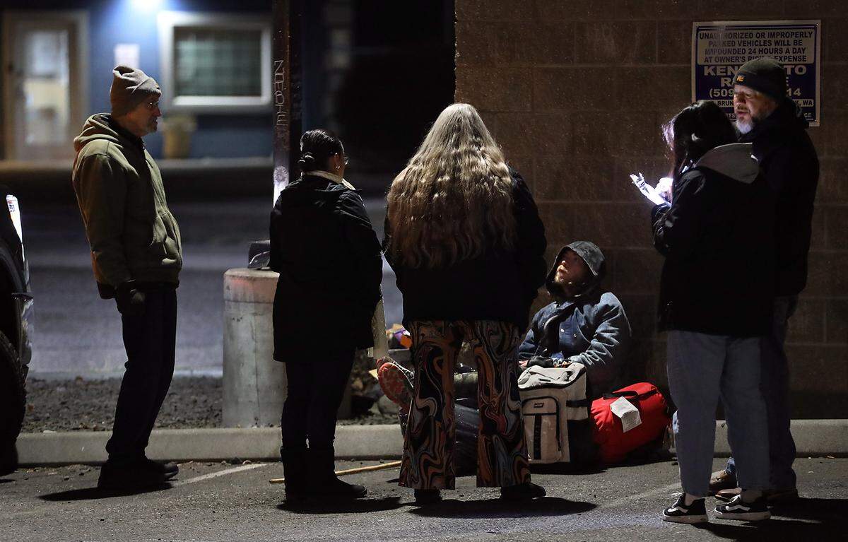 Several hours before daylight, volunteers and others taking part in the annual Point in Time count talk to Ryan Willams, 28, of Hermiston. They spotted him huddled outside in 20 degree temperatures near a dumpster behind a business just off Vista Way in Kennewick.