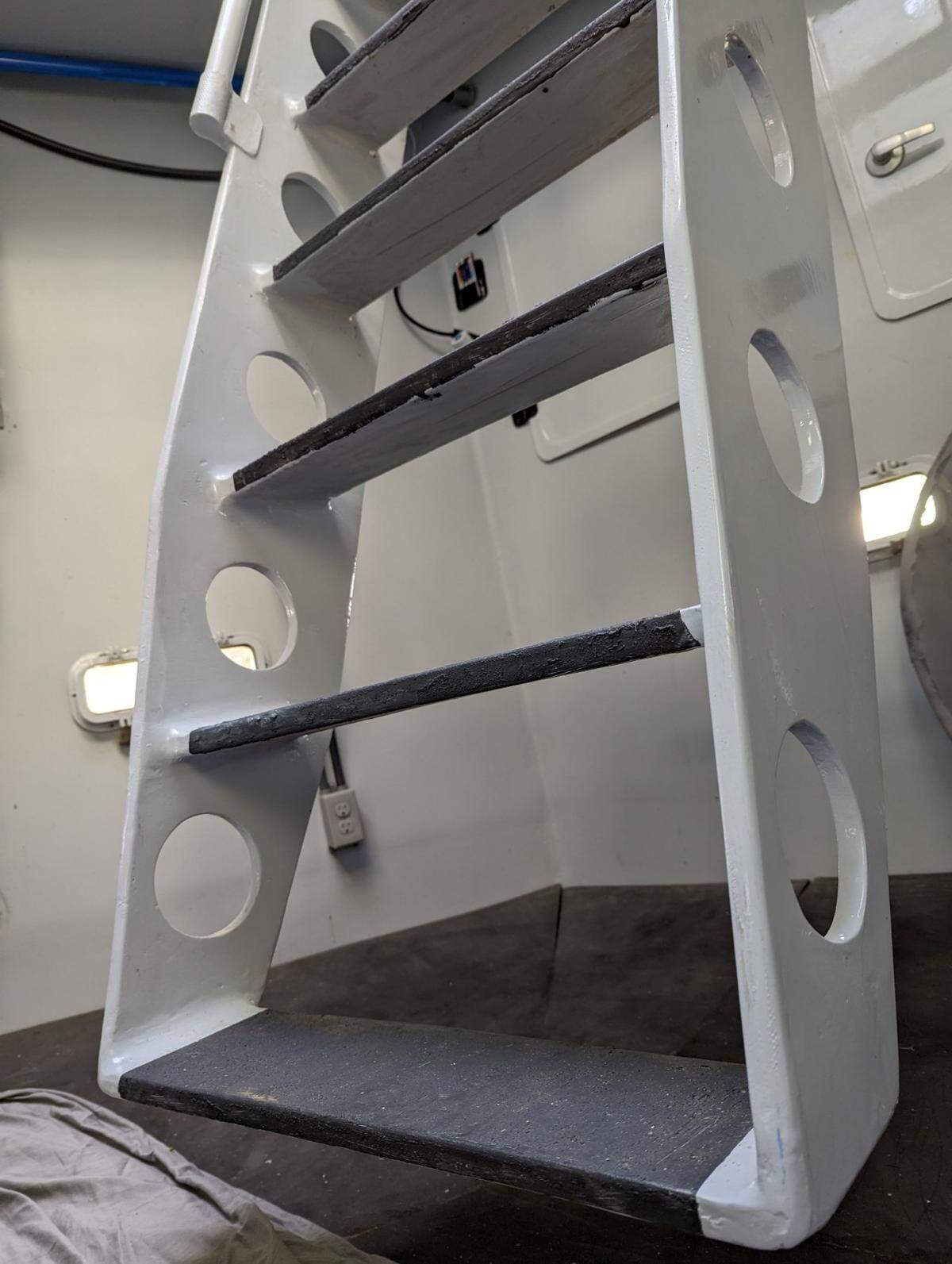 Steep stairs lead to the bedchamber at the base of Kurt Hughes’ lunar lander home.