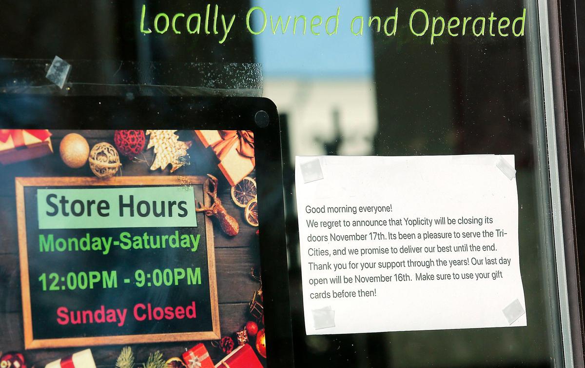 A sign posted on the door of the Yoplicity frozen yogurt business on West 27th Place in Kennewick announces the pending closure of the store.