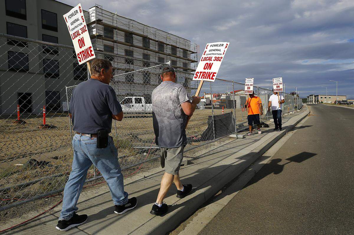 These picketers were outside the motel construction project Friday morning off Earhart Drive near the Tri-Cities Airport in Pasco. IUOE Local 302 represents heavy equipment operators who run excavators, cranes, bulldozers and other construction equipment.