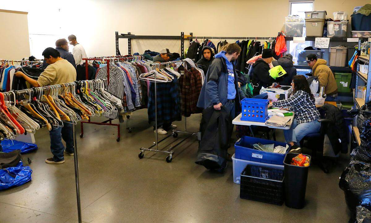 Homeless people choose from a room filling with donated clothing items at the Tri-City Union Gospel Mission at 221 S. 4th Ave. in Pasco.
