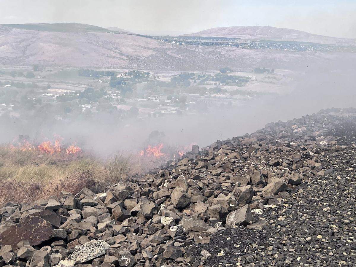 The Country Meadows Fire spread quickly uphill in dry and breezy conditions on Saturday.