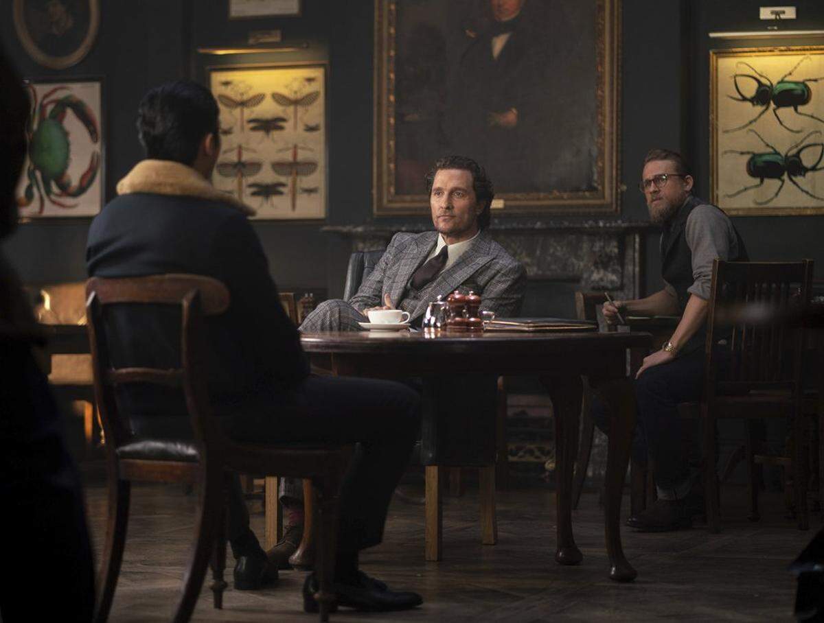 This image released by STXfilms shows, from left, Henry Golding, Matthew McConaughey and Charlie Hunnam in a scene from “The Gentlemen.”