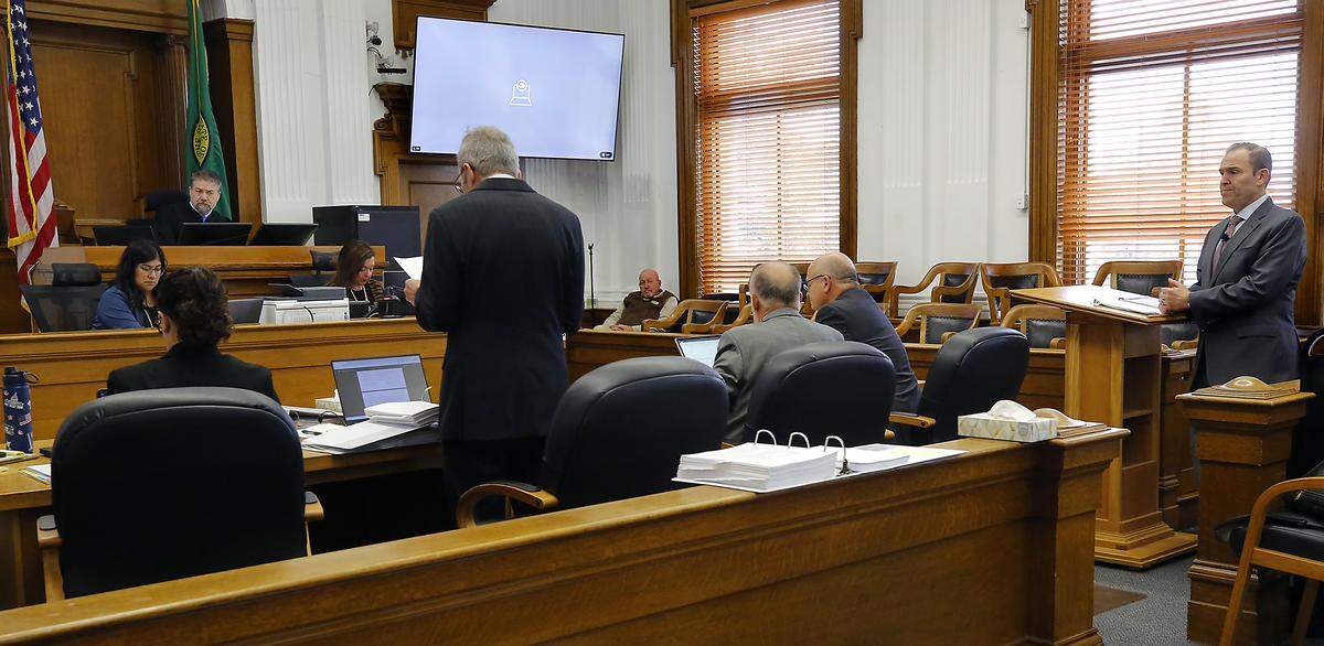 Superior Court Judge Brandon Johnson listens to motions by Benton County attorney Andrew Cooley, left, and plaintiff attorney Eron Cannon  in a Walla Walla courtroom during the second day of the trial.