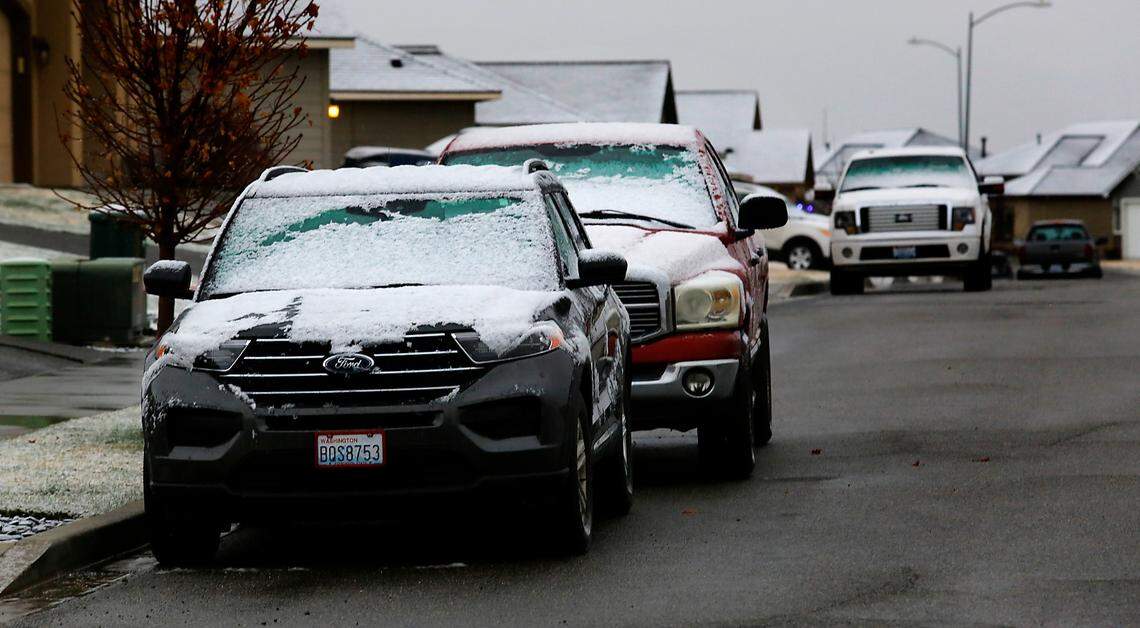 A wet heavy snow covers cars parked outside off Southridge Boulevard in Kennewick early Monday morning as a spring snow storm blankets many areas around the Mid-Columbia.