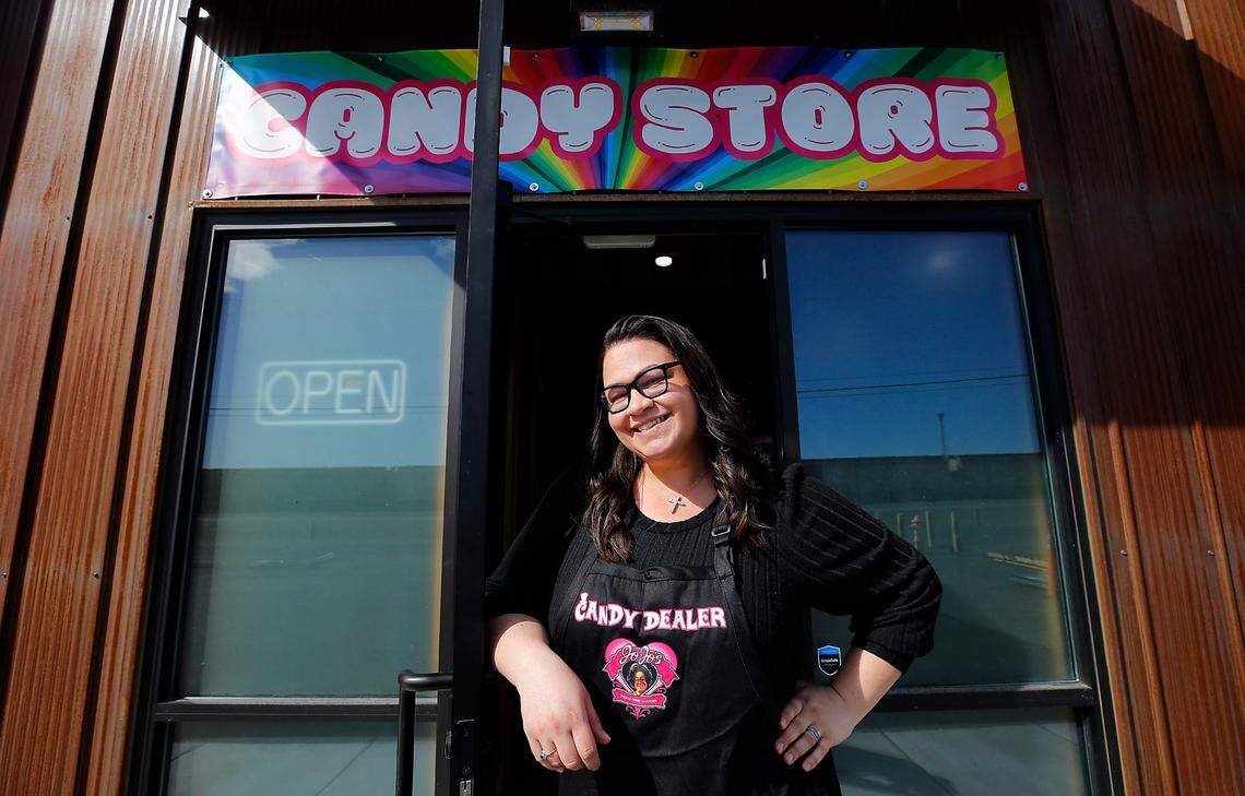Sarra Hendrick stands at the front door JoJo’s Freeze-Dried Goodies manufacturing space and candy store east of the Tri-Cities Airport in Pasco.