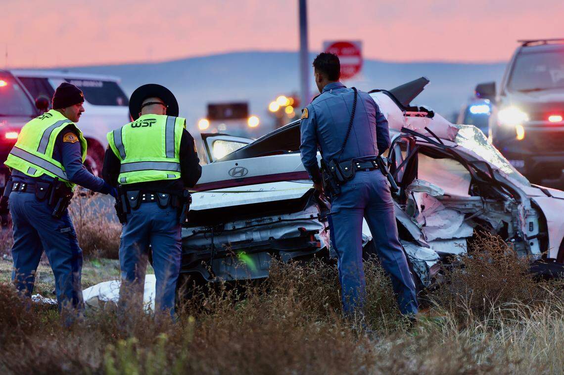 Washington State Patrol troopers investigate a two-vehicle crash near Highway 395 and East Vineyard Road early Tuesday. One person died in the collision.