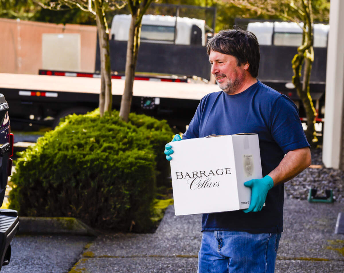 Kevin Correll, owner/winemaker of Barrage Cellars in Woodinville, Wash., completes a curbside delivery.