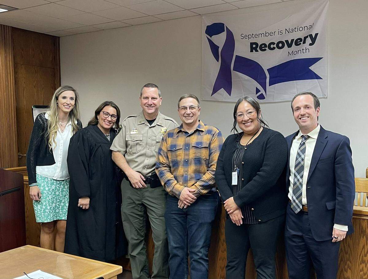 Dustin Sydnes, center, pictured here with the other members of the therapeutic courts.