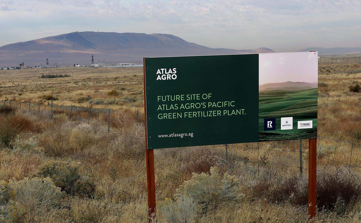 A sign installed on Horn Rapids Road near the intersection with Stevens Drive in north Richland announces the future site of Atlas Agro's Pacific Green Fertilizer Plant. 