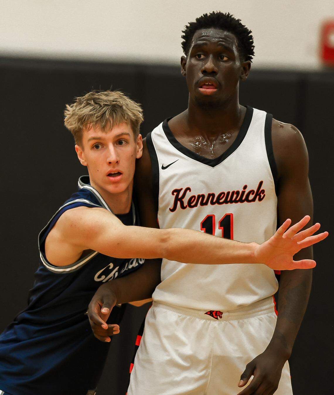 Kennewick’s Daniel Trotenya is guarded by Chiawana’s Devin Davis in a January 2026 game.