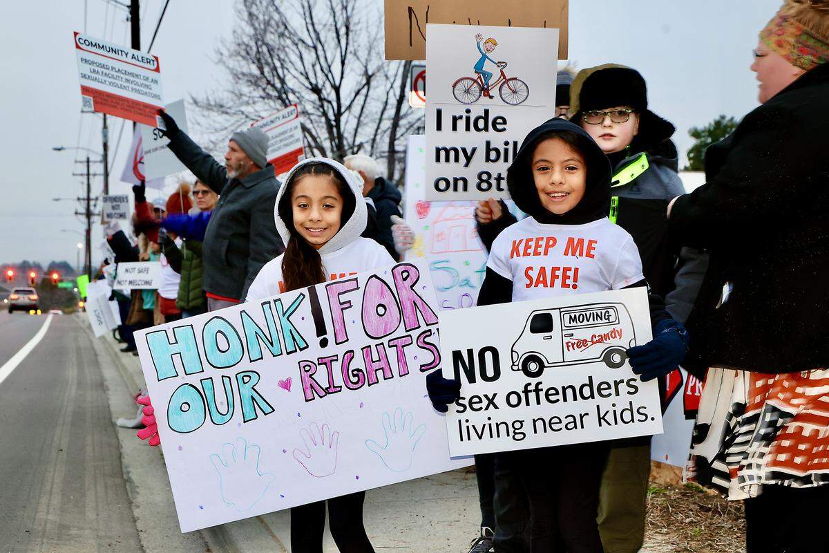Local families and residents of West 8th Avenue protest along Edison Street in Kennewick.