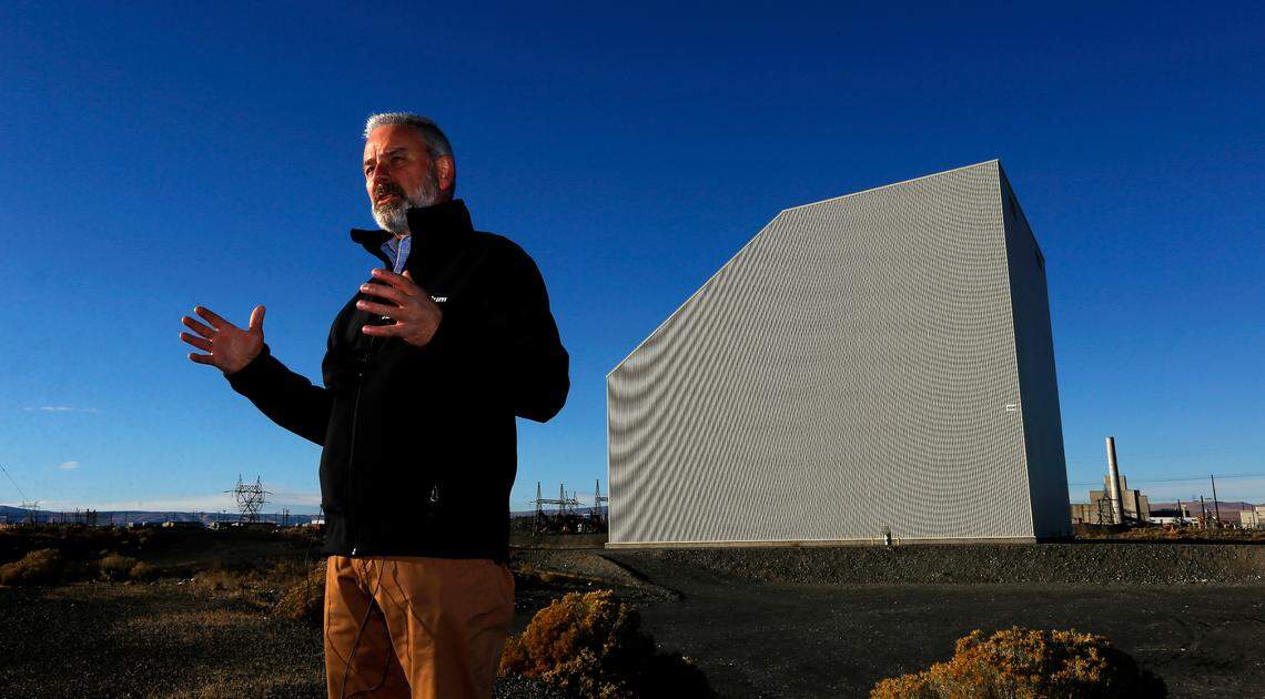 John Eschenberg, president of Central Plateau Cleanup Co., shows off the recently completed “cocooning” of the K East Reactor at Hanford. The K West Reactor, yet to be cocooned, is in the background.