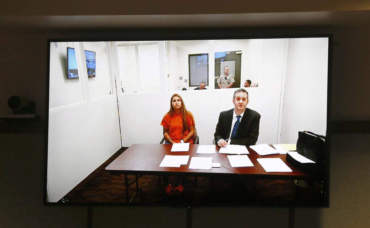Claudia Y. Rizo appears on a closed-circuit TV screen with provisional defense attorney Michael Quillen in Franklin County Superior Court. She’s being held on investigation of drive-by shooting, assault and burglary after a fight at a weekend party.
