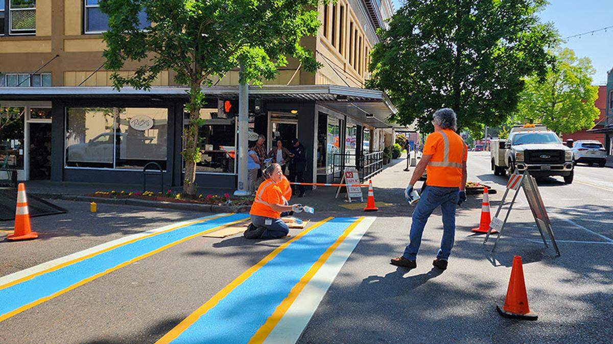 The transgender pride flag is being painted on two crosswalks in downtown Olympia.