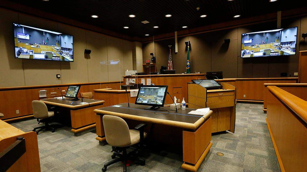 Video monitors cover the walls and desks in Benton County Superior Court courtroom D which has been designated as the public viewing area for jury trials using digital video capabilities during the ongoing coronavirus pandemic.
