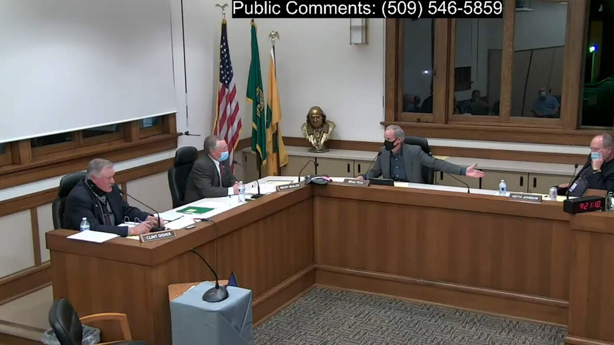 From left, Franklin County commissioners Clint Didier, Rocky Mullen and Brad Peck argue over Mullen’s motion to fire County Administrator Keith Johnson, right, at the April 6 commission meeting.