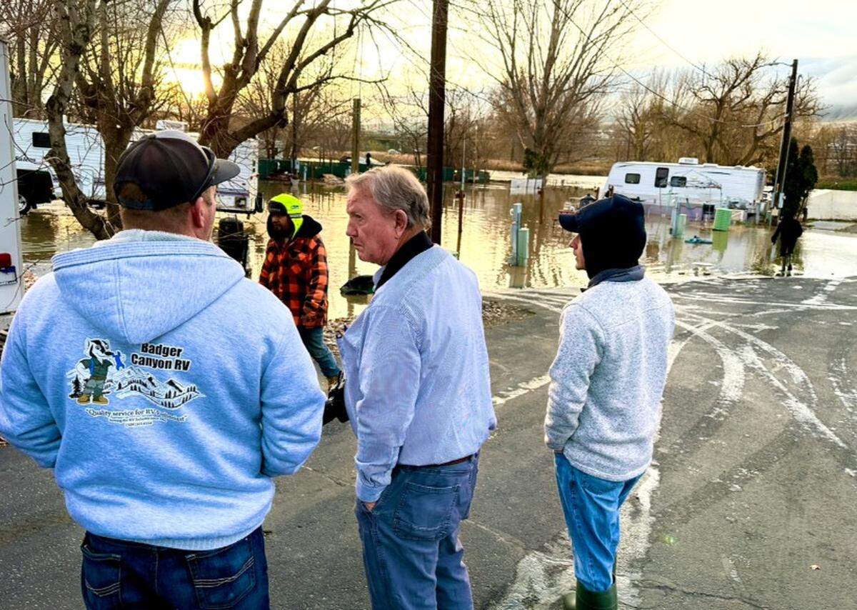 From left, Justin Marshall, Badger Canyon RV, Benton City Mayor Len Burton and city building inspector Zach Prindell assess the damage last weekend at the flooded RV park along the Yakima River.