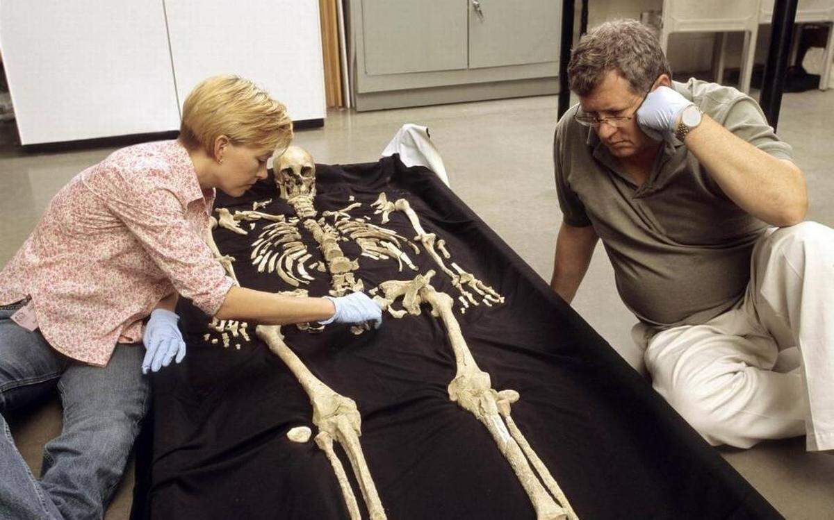 Smithsonian physical anthropologists Karin Bruwelheide, left, and Doug Owsley discuss the position of the Kennewick Man skeleton during an anatomical layout of the remains in this file photo.