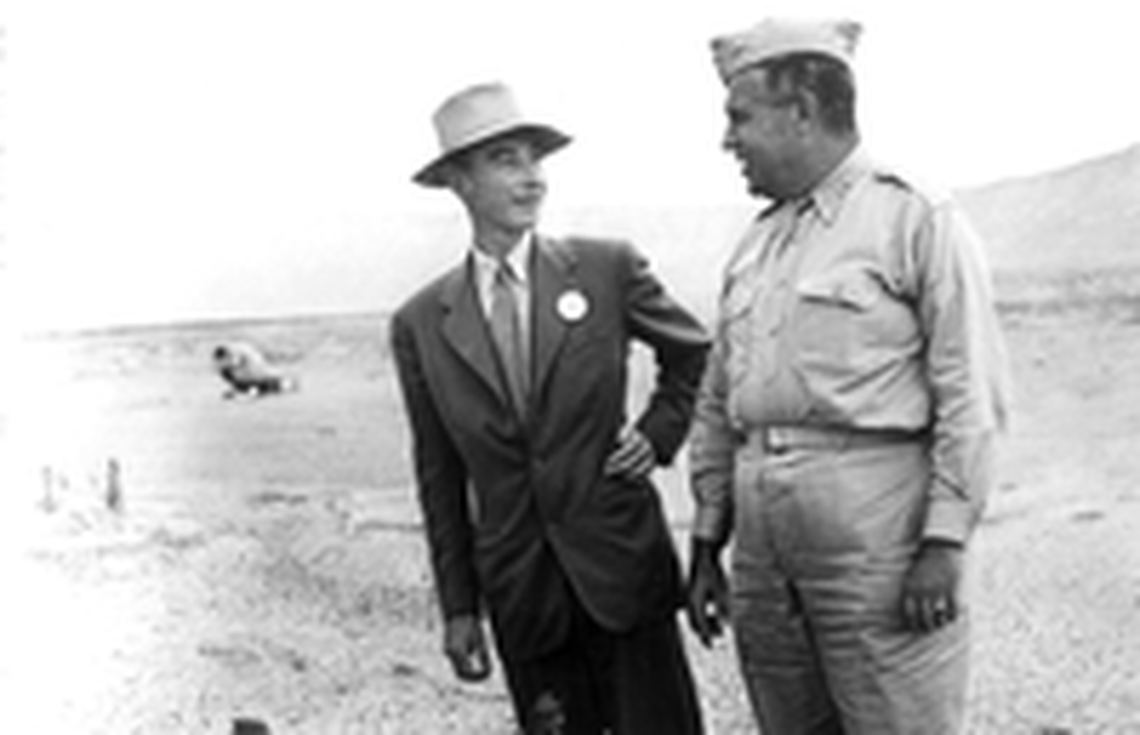 J. Robert Oppenheimer and General Leslie R. Groves at Trinity Site next to the remains of the Trinity Tower in September 1945.