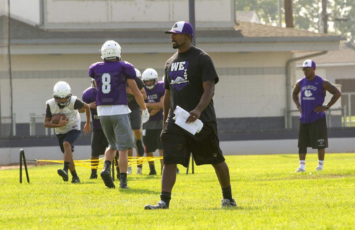 Pasco High School football coach Leon Wright-Jackson observes his team during a recent practice. Wright-Jackson is a former Bulldog running back who played on the 2003 state championship team.