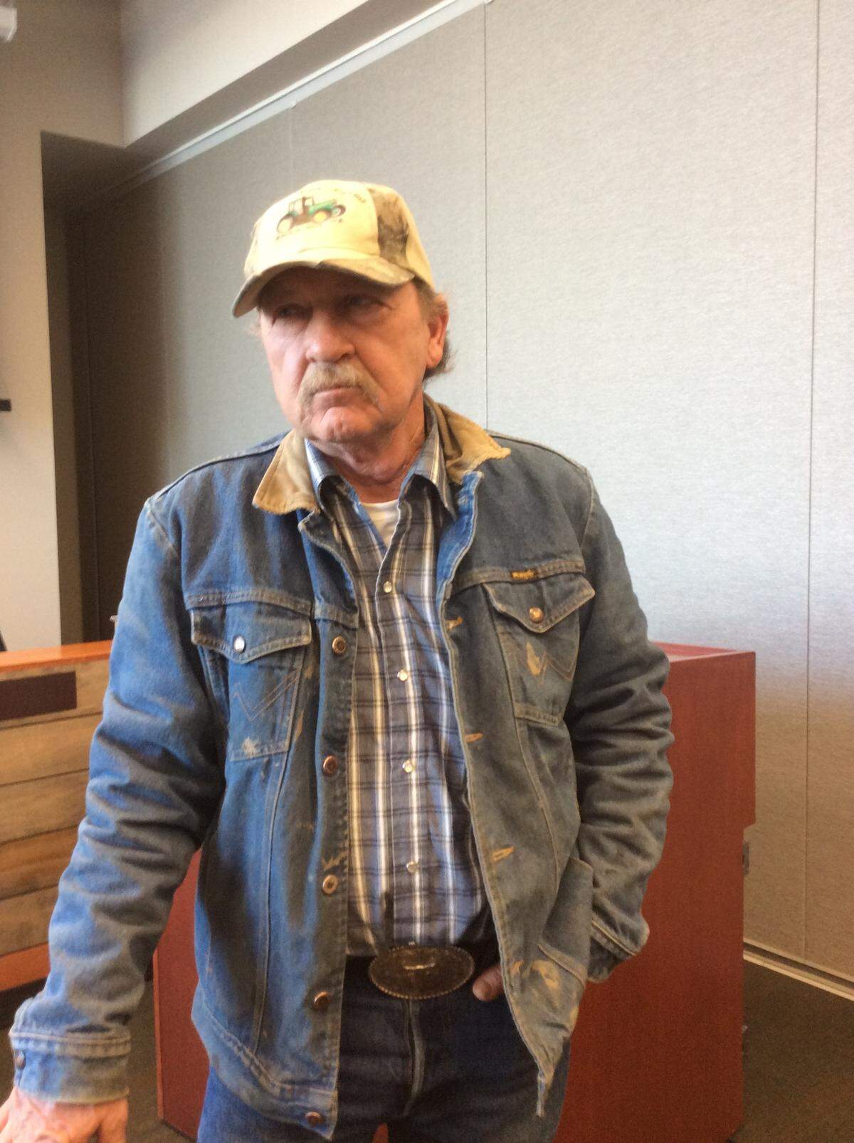 Robert S. Cox waits during a break in the Kennewick Irrigation District Board meeting to discuss a possibly condemnation of his family farm in Badger Canyon.