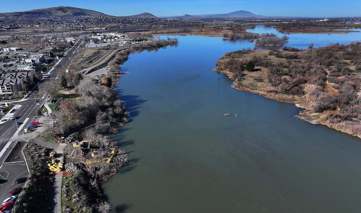 A sediment plume from the Yakima River freely flowing past Bateman Island in Richland is visible blending with the Columbia River.
