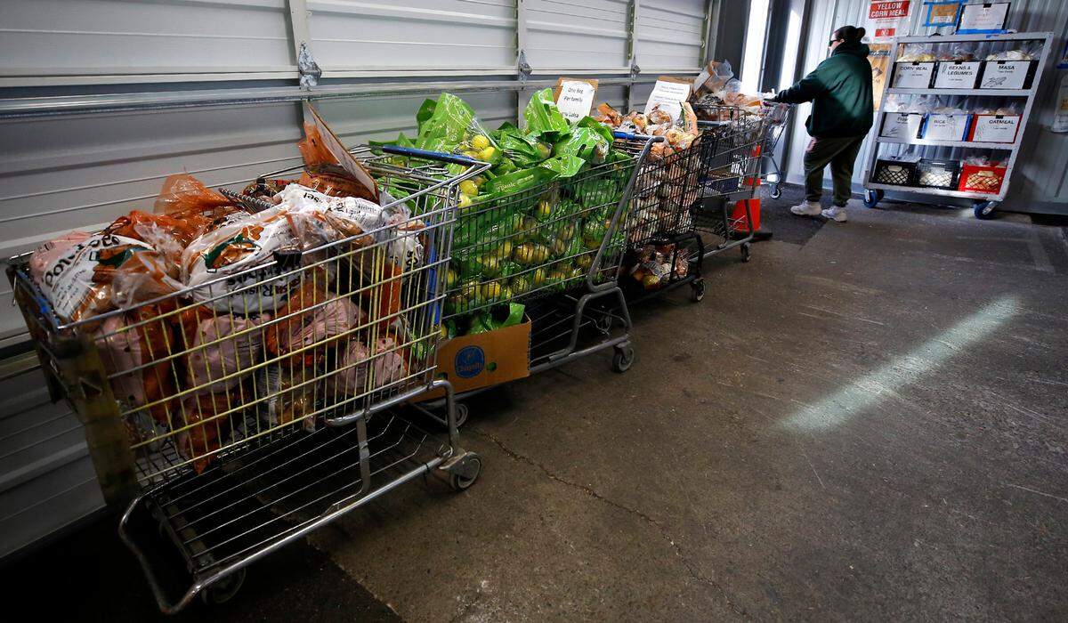 A client leaves with a filled cart at the Tri-Cities Food Bank in downtown Kennewick.