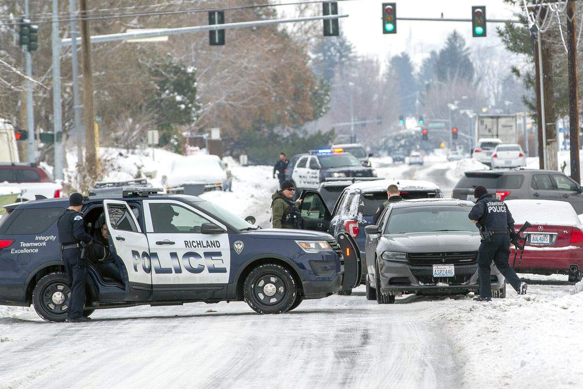 Richland police and SWAT surround home on Williams Boulevard on Friday in connection to the early morning shooting that took place near Sanford Boulevard in Richland.