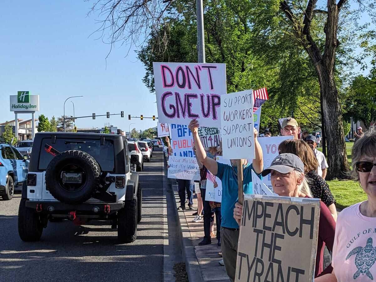 Hundreds of protesters waved signs and 5 p.m. commuters honked back in support of a May Day protest held Thursday at John Dam Plaza.