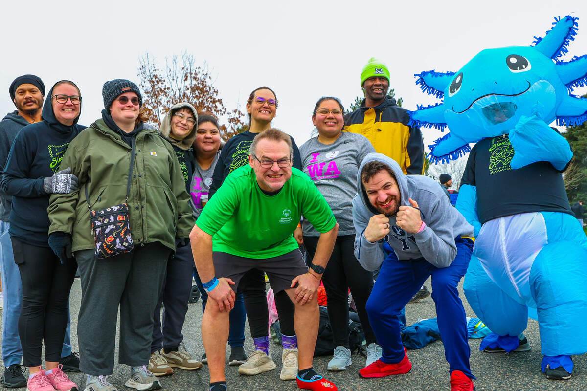 Participants with The Arc of Tri-Cities pose before taking part in the Special Olympics-Washington Polar Plunge at Columbia Point Marina Park in Richland.