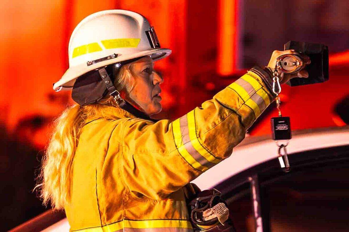 Duty Chief Bonny Rogers uses a thermal imaging camera to locate hidden hot spots following an early morning residential fire in the 5200 block of Jacksnipe Court. Firefighters used the camera to detect heat inside walls and floors during overhaul operations.
