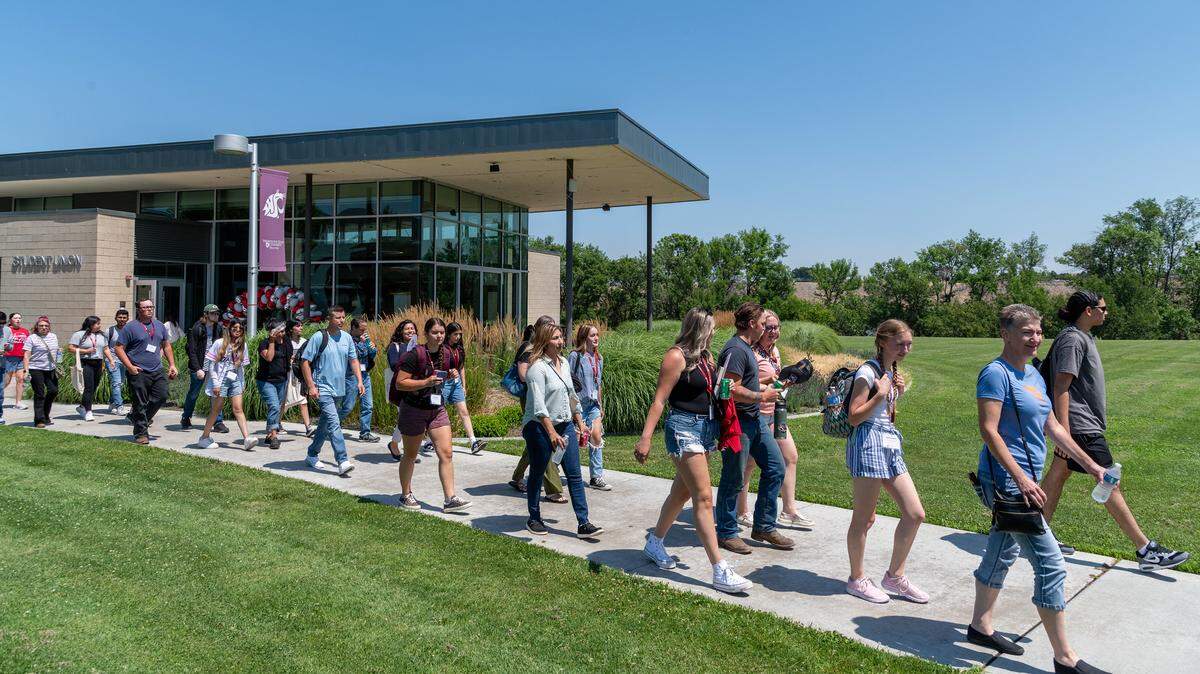Washington State University Tri-Cities students and staff walk past the Student Union Building.