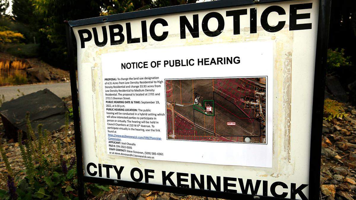 A sign posted by the City of Kennewick announces a public hearing about a proposal for a change in the land use designation of about 40 acres on top of Thompson Hill in Kennewick. The hearing date is scheduled for September 19, at 6:30 p.m. in the Kennewick council chambers.