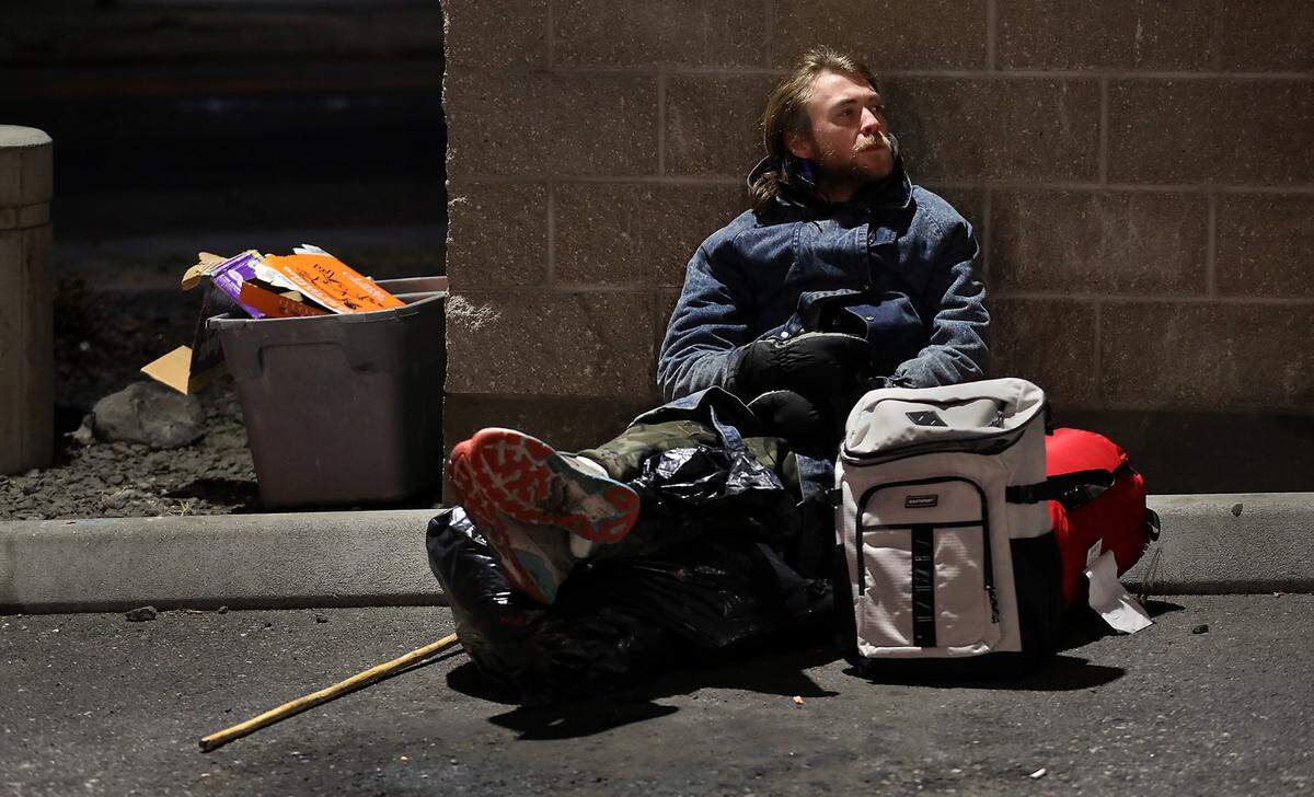 Ryan Williams, 28, of Hermiston huddles by a dumpster in 20 degrees temperatures and hours from sunrise after talking with the folks conducting the annual Point in Time homeless count. They spotted outside near a business off Vista Way near Highway 395 in Kennewick.