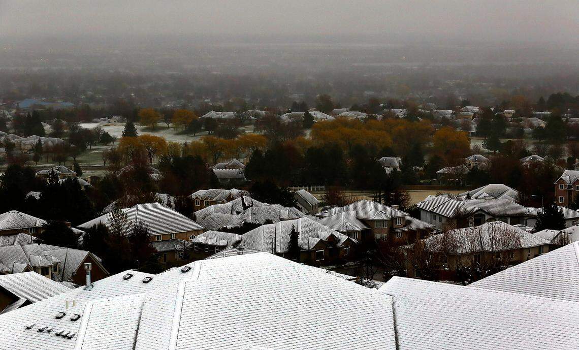 A wet heavy snow covers the roofs of homes just south of the Canyon Lakes Golf Course in Kennewick as a spring snow storm blankets many areas around the Mid-Columbia.