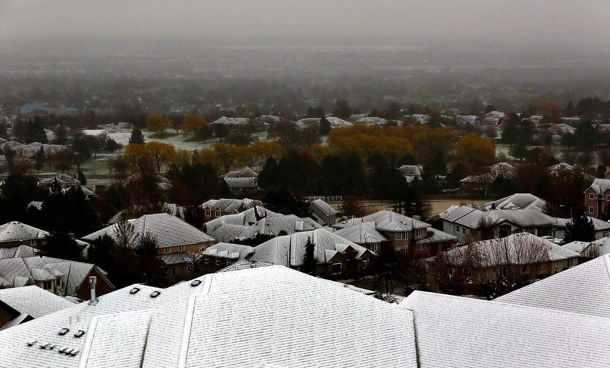 A wet heavy snow covers the roofs of homes just south of the Canyon Lakes Golf Course in Kennewick as a snow storm blankets many areas around the Mid-Columbia.
